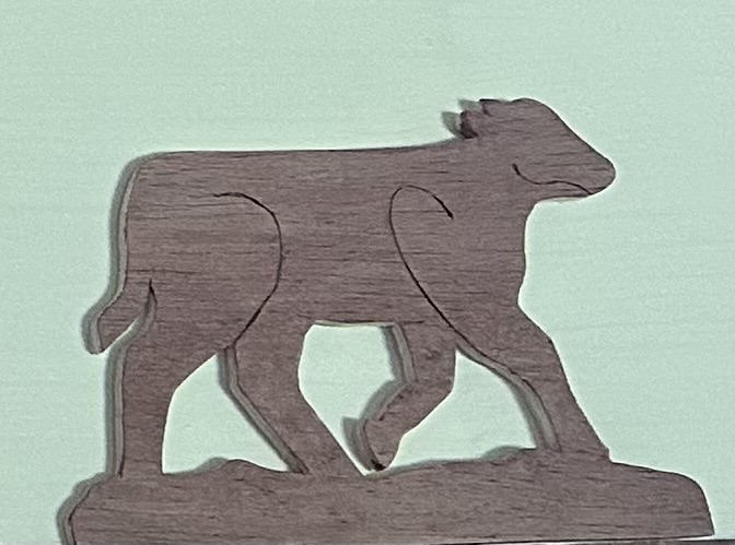 Delicate baby cow cutout in oak