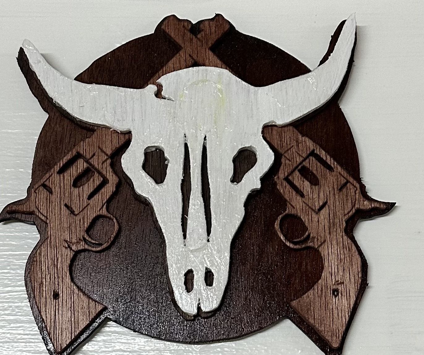 Scroll-saw skull and crossbones wall art